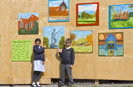 Primary school children created paintings to decorate the hoardings. Select the image to see a larger view