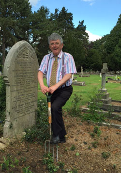 Volunteer, Simon Trehearne, helps to clear the Haywood family graves